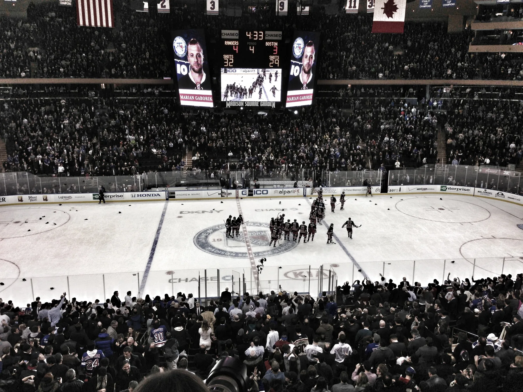 Rangers players celebrate on the ice at Madison Square Garden as hats rain down.