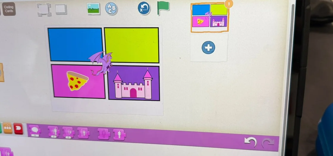 A Spaght student project in ScratchJr, with a dragon, pizza slice, and castle