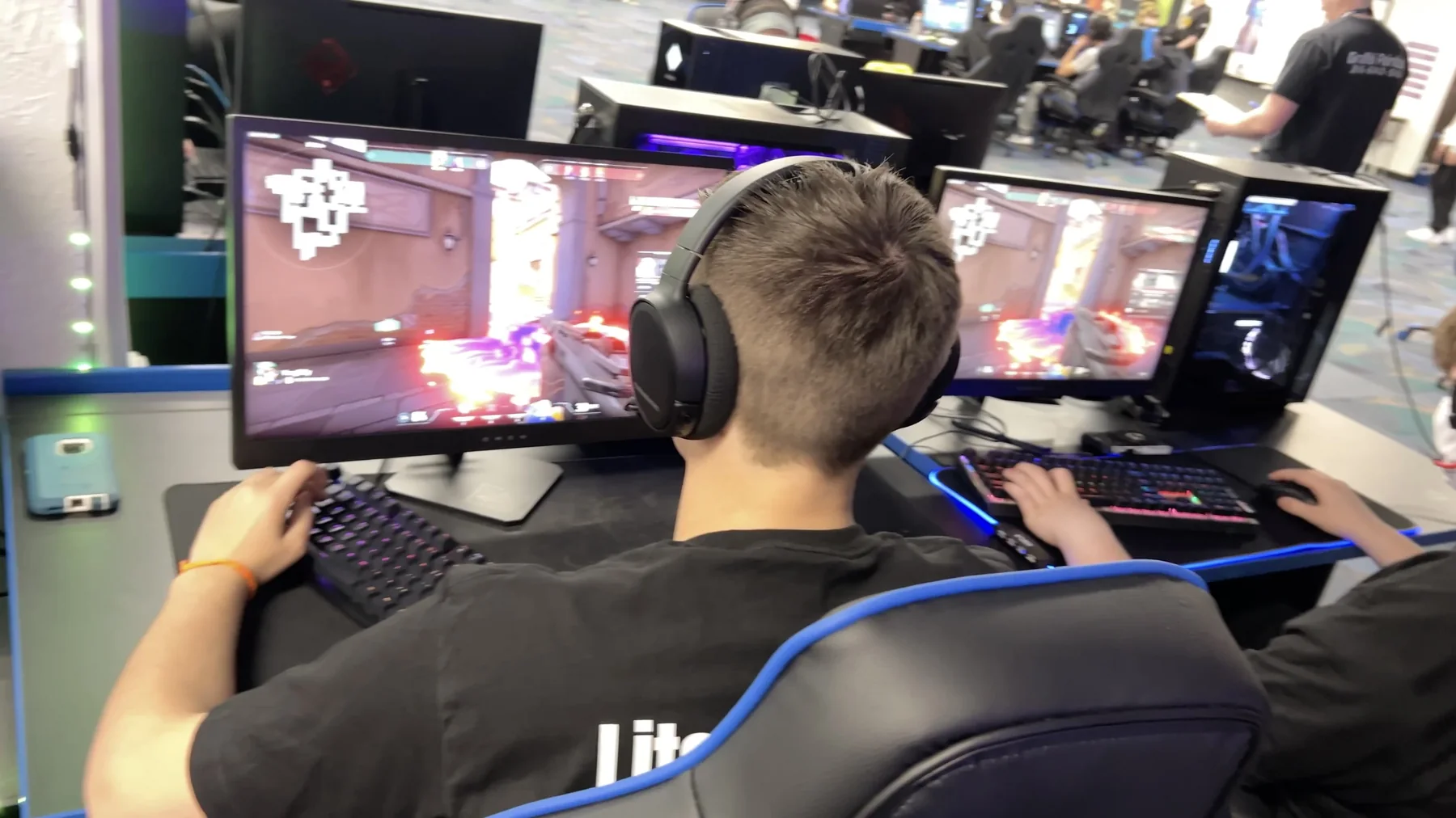 Students wearing headsets play Overwatch at Wichita Public Schools esports stations